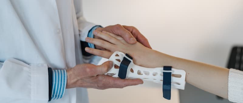A wrist splint and hand exerciser on a physiotherapist's desk