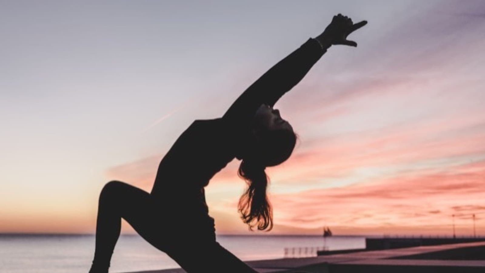 A sunset stretch silhouette by the sea