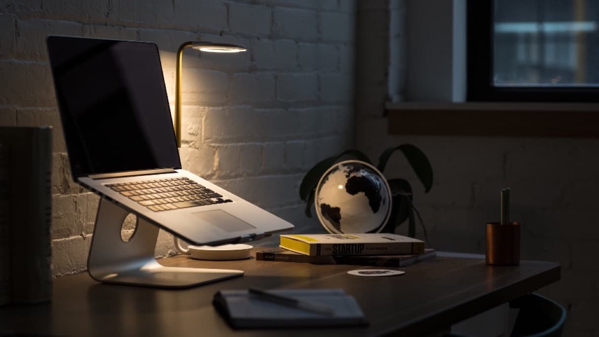 A standing desk raised to full height in a home office