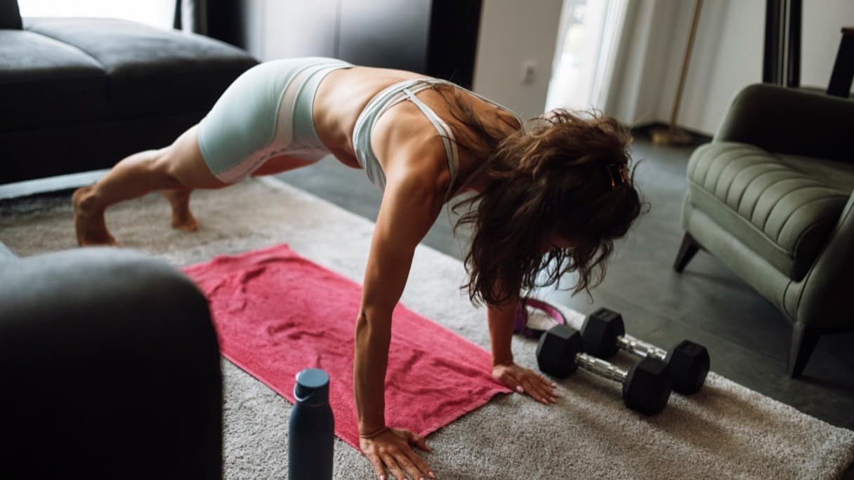 A rolled exercise mat and resistance bands in the corner of a living room