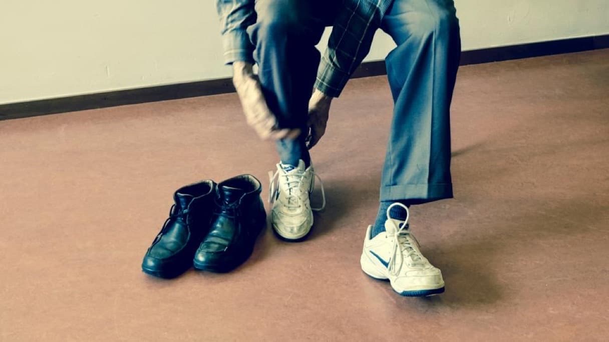 Running shoes and a foam roller on a physiotherapy clinic floor